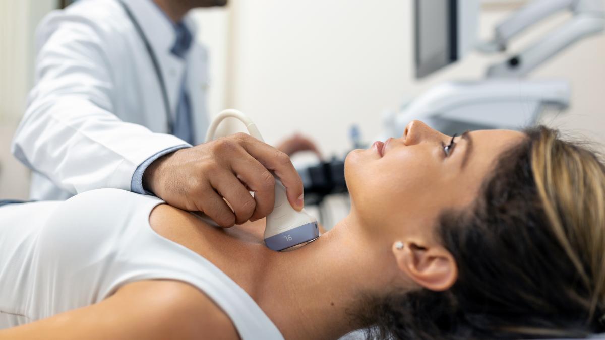 close-up-shot-young-woman-getting-her-neck-examined-by-doctor-using-ultrasound-scanner-modern-clinic_05050300
